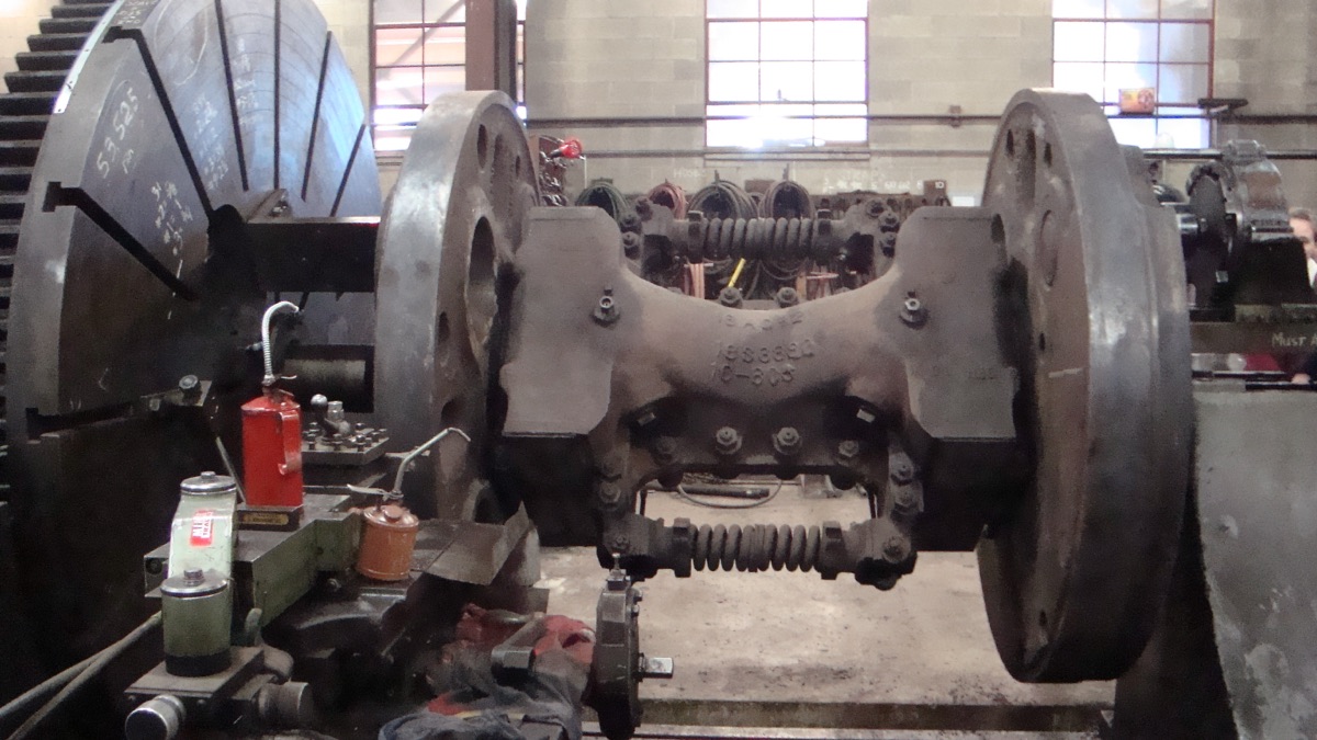 A pair of 4014's massive driving-wheel sets mounted on a quartering lathe in the Cheyenne steam shop, mid-restoration.